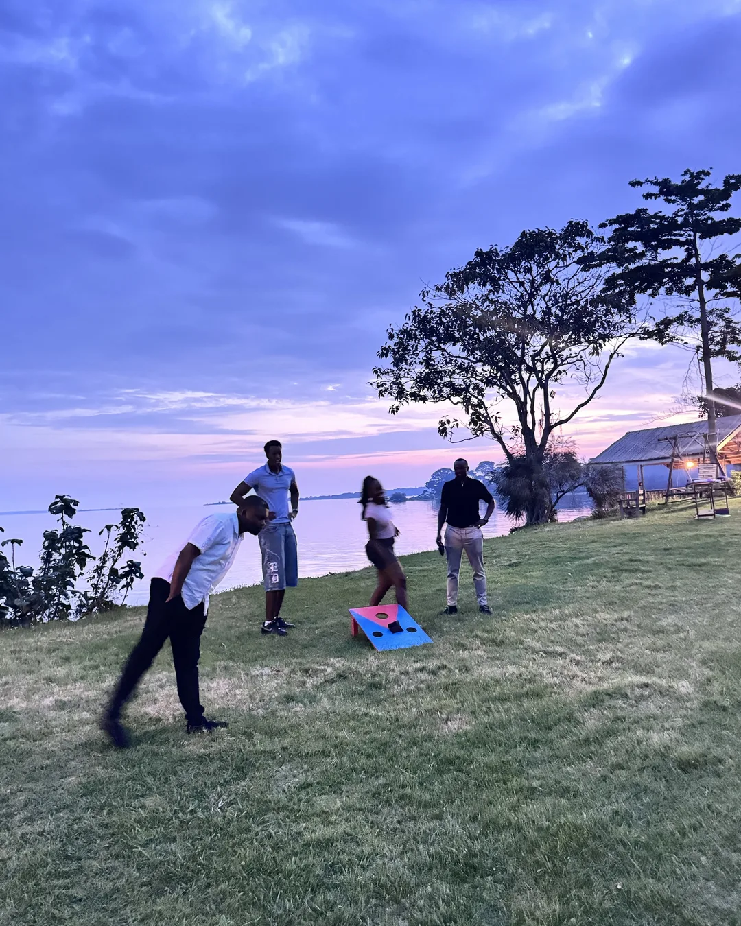 Bean bag toss on the lawn at sunset